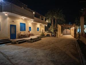 a house with a courtyard at night at Slow Tunis in Fayoum Center