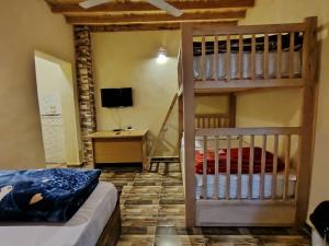 a bedroom with a bunk bed and a desk at Slow Tunis in Fayoum Center