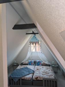 a bedroom with a bed in a attic at Ferienwohnung Ella in Dinkelsbühl +12 photos