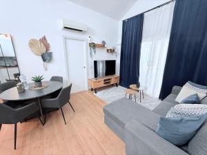 a living room with a couch and a table at HDFM Collection - Bungalow Playa del Inglés in Playa del Ingles