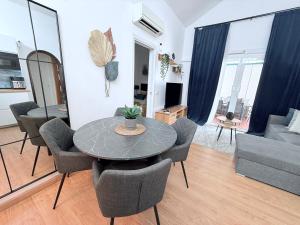 a living room with a table and chairs and a couch at HDFM Collection - Bungalow Playa del Inglés in Playa del Ingles