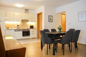 a kitchen and dining room with a table and chairs at Apartment Piano in Rijeka