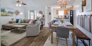 a dining room and living room with a table and a couch at FAMILY Friendly Sleeps 10 4 Bedrooms King Bed & Pets in Valdosta