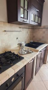 a kitchen with a stove and a counter top at Residenza IV Novembre in Settimo Torinese