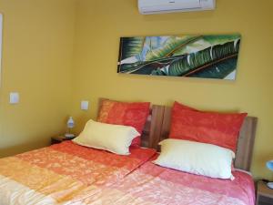 a bedroom with two beds with red and white pillows at Junior-Suite Merlot in Cape Town +36 photos