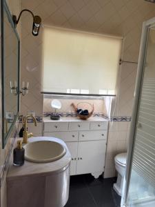 a bathroom with a sink and a toilet at Moinho da Saudade in Alcabideche