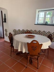 a table with chairs and a white table cloth on it at Moinho da Saudade in Alcabideche +8 photos
