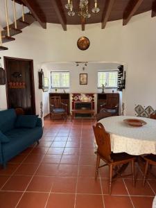 a living room with a table and a couch at Moinho da Saudade in Alcabideche