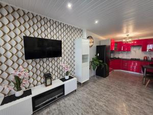 a living room with a flat screen tv on a wall at Lawendowy dworek in Paszowa