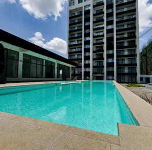 a large swimming pool in front of a building at SoulCare Haven in Syokimau