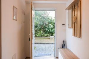 an open door leading to a garden outside at Apartment Piano in Rijeka