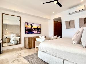 a bedroom with a bed and a living room at Harbor NT507 by Moikkarentals in Puerto Vallarta +67 photos
