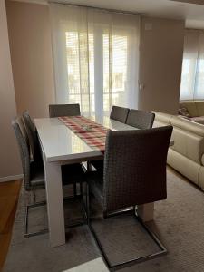 a dining table and chairs in a living room at Iris Luxury Apartment in Ohrid +3 photos