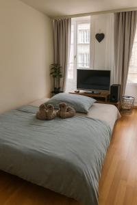 two stuffed animals sitting on top of a bed at Central & cosy next to cathedral in Fribourg