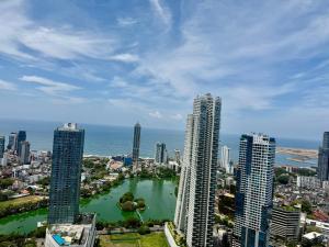 a city with tall buildings and a body of water at Trizen Colombo stylish high rise condo -Vistablu 32 in Colombo
