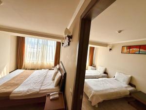 a hotel room with two beds and a window at New Nairi Hotel Yerevan in Yerevan +53 photos