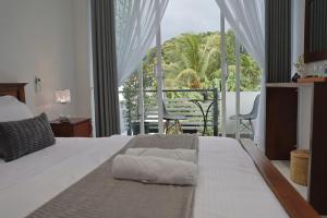 a bedroom with a large bed and a large window at K's Cove in Kandy +51 photos