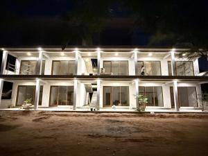 a large white house at night with lights at Lily Mirissa in Mirissa