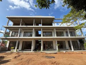 a large white building with windows on top of it at Lily Mirissa in Mirissa