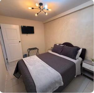a bedroom with a bed and a tv on the wall at Family Condo in San Felipe