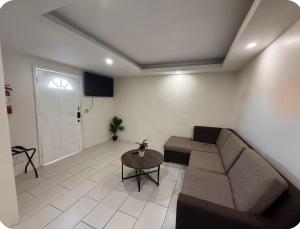 a living room with a couch and a table at Family Condo in San Felipe