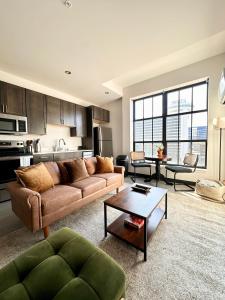 a living room with a couch and a table at Deer District Studio Apt - One Block from Fiserv and Baird in Milwaukee