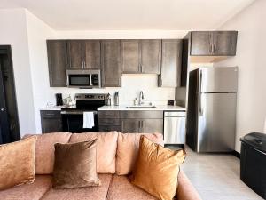 a living room with a couch in a kitchen at Deer District Studio Apt - One Block from Fiserv and Baird in Milwaukee