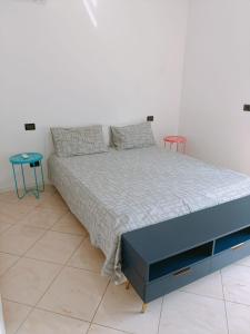 a bedroom with a large bed with two tables at Aeroporto & Fiera 30 in Seriate