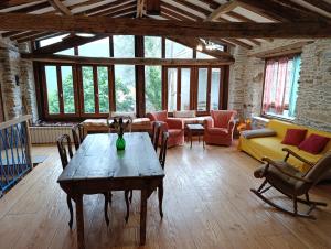 a large living room with a table and chairs at Villa Art Razzamir in Ponte di Nava