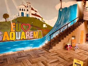 a mural of a building with a mural of a lighthouse at Pousada Dourados de Itaúna in Saquarema