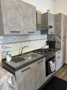 a kitchen with a sink and a stove at HOLIDAY HOME ROMA LacasadiValentina in Rome