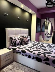 a bedroom with a bed with black and white pillows at Iris Luxury Apartment in Ohrid