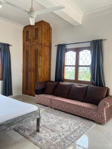 a living room with a couch and a window at Casuarina Villa in Malindi