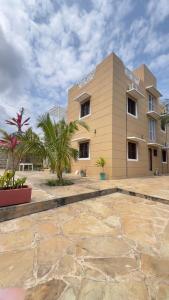 a large building with palm trees in front of it at Casuarina Villa in Malindi +29 photos