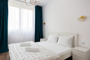 Ένα ή περισσότερα κρεβάτια σε δωμάτιο στο Sika Metropolis Grand Apartment