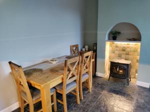 a dining room with a table and a fireplace at Parkdale-2 Bedroom House in Sheldon Birmingham in Birmingham