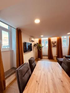 a living room with a wooden table and chairs at Living Funchal Executive in Funchal +134 photos