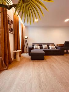a living room with a couch and a table at Living Funchal Executive in Funchal