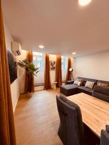 a living room with a couch and a table at Living Funchal Executive in Funchal +134 photos