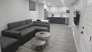 a living room with a couch and a table at Royaldee Cozy Home 2beds & 2baths in Calgary