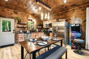 a kitchen with a table and a refrigerator at Romancing the Stone in Sevierville