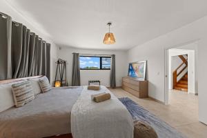 a bedroom with a large bed and a window at 3 bedroom cozy villa close to Jan Thiel Beach in Jan Thiel