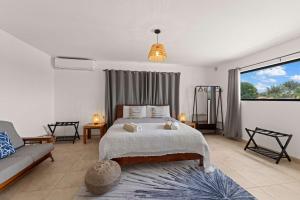 a bedroom with a bed and a couch at 3 bedroom cozy villa close to Jan Thiel Beach in Jan Thiel +42 photos