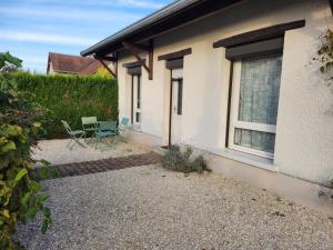 a house with two chairs and a window at Chez David et Julie in La Bouverie +2 photos