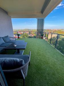 a living room with a couch and a table on a balcony at Violet Suite in Nyíregyháza