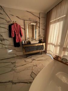a bathroom with a bath tub and a sink at Violet Suite in Nyíregyháza +41 photos