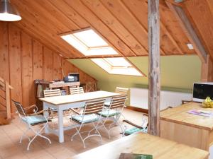 a room with a table and chairs in a attic at Quaint Farmhouse in Houffalize with Terrace in Halonreux