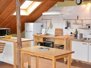 a kitchen with a wooden table in a room at Quaint Farmhouse in Houffalize with Terrace in Halonreux