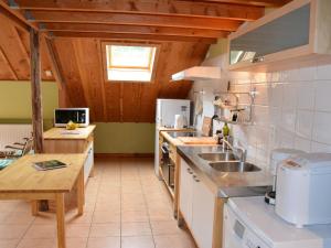 a kitchen with a sink and a counter top at Quaint Farmhouse in Houffalize with Terrace in Halonreux