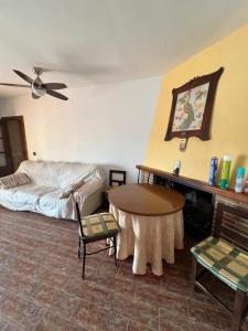 a bedroom with a bed and a table and chairs at Cortijo Los Periquitos  +23 photos